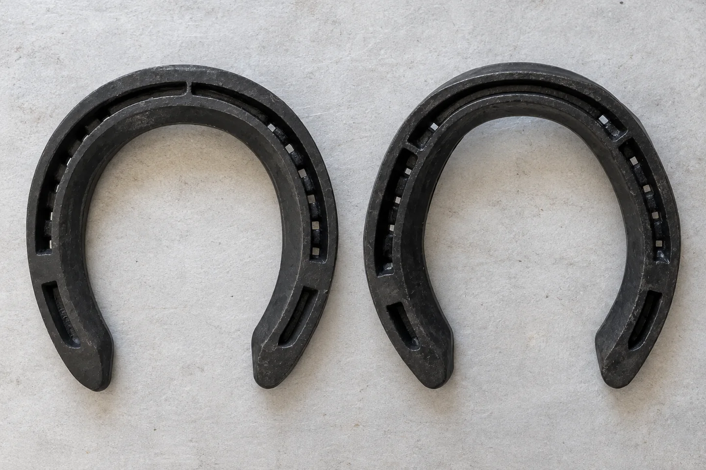 Two unclipped steel horseshoe outlines arranged for comparison