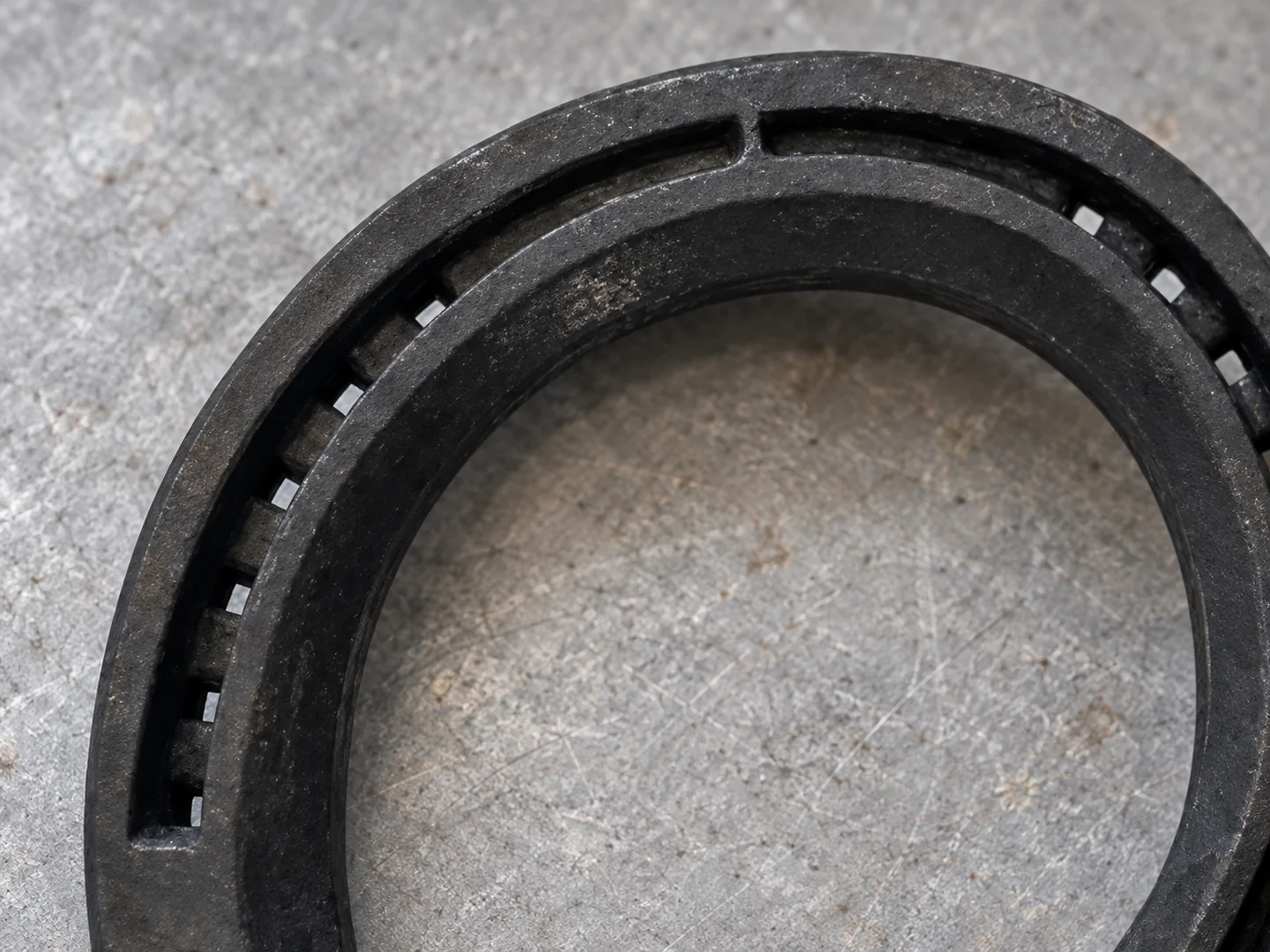 Close view of a steel horseshoe toe arc, recessed nail channel and nail holes