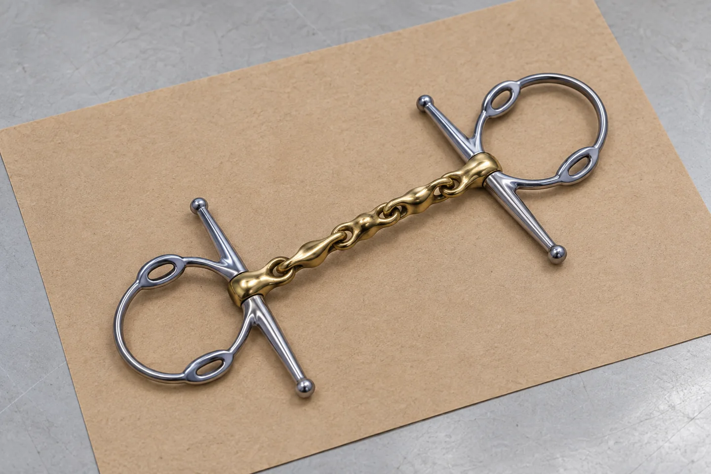 A complete horse bit with contrasting mouthpiece and cheek finishes