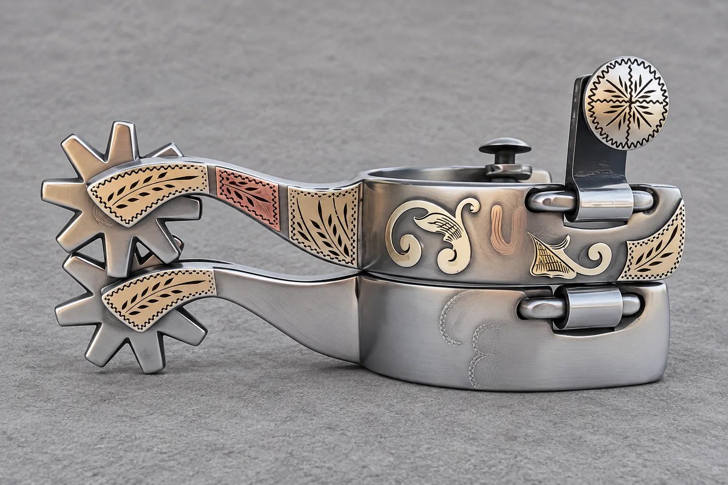 A pair of decorated Western spurs with star-shaped rowels