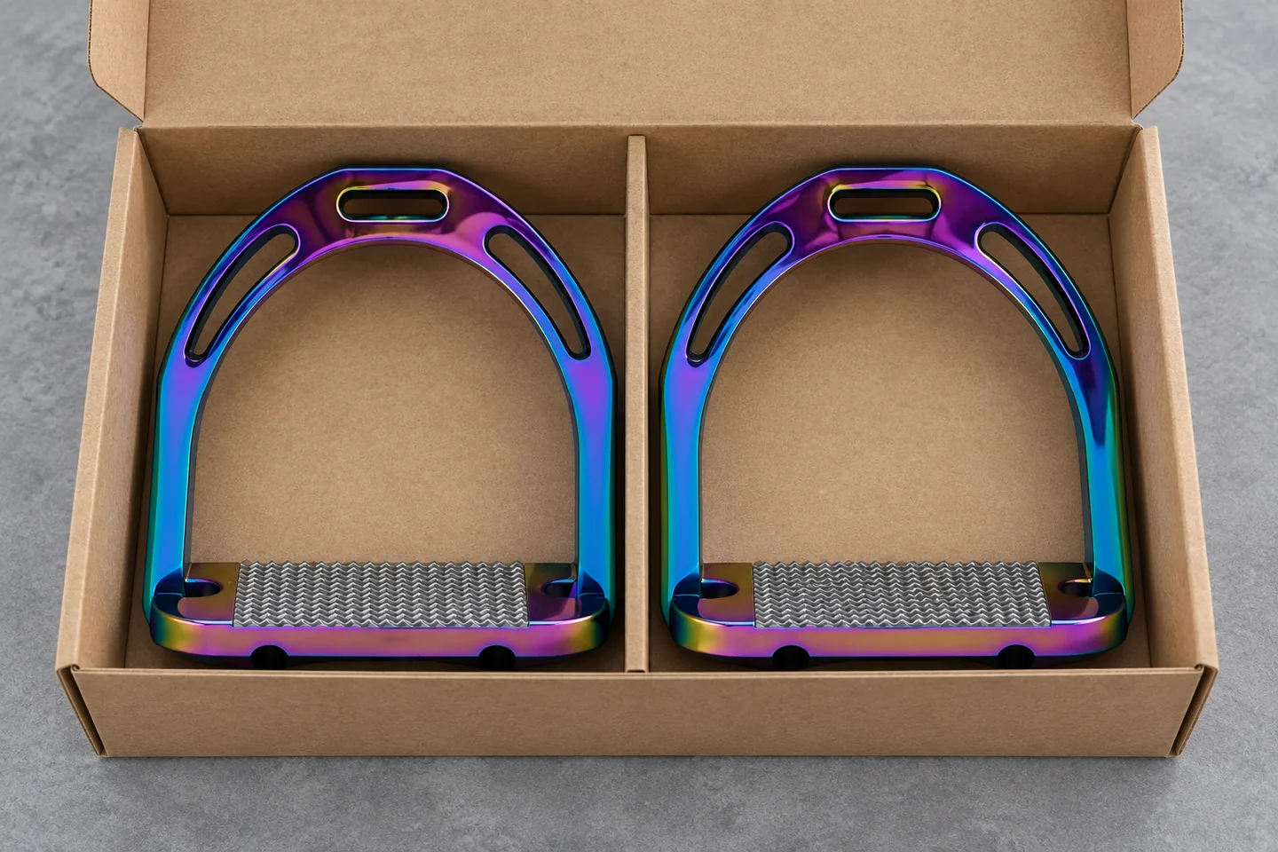 A matching pair of stirrups arranged in a plain divided kraft box