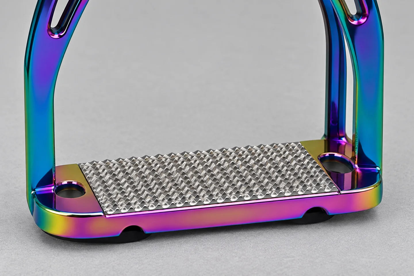 Close view of a textured stirrup tread and its lower frame connection