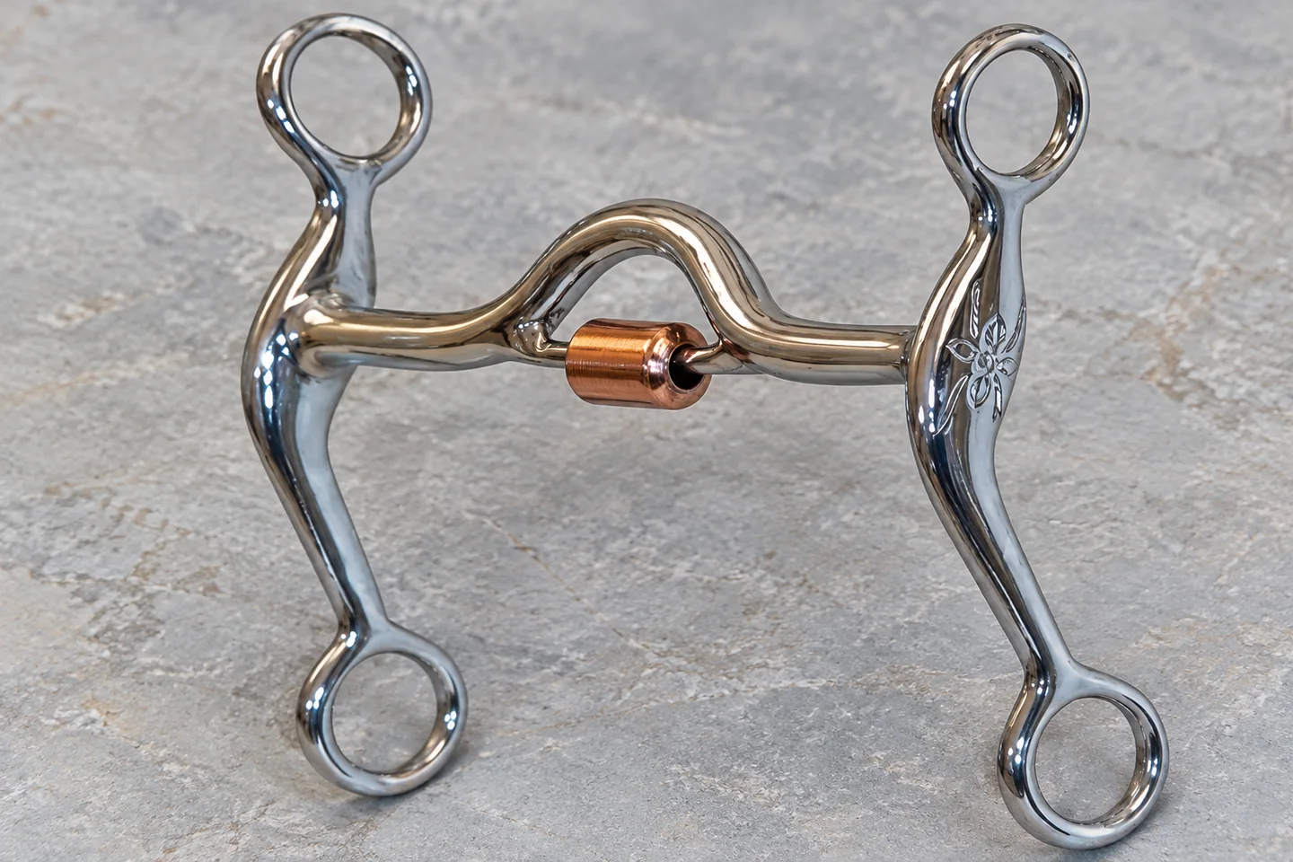 Detail of the arched mouthpiece and copper-colored roller on the reference bit